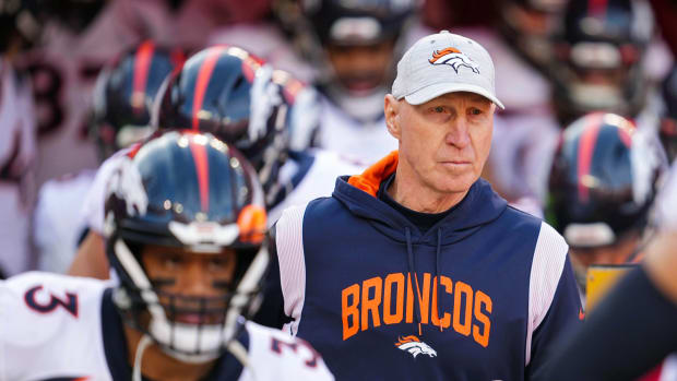 Denver Broncos interim head coach Jerry Rosburg and quarterback Russell Wilson (3) take the field prior to a game against the Kansas City Chiefs at GEHA Field at Arrowhead Stadium.